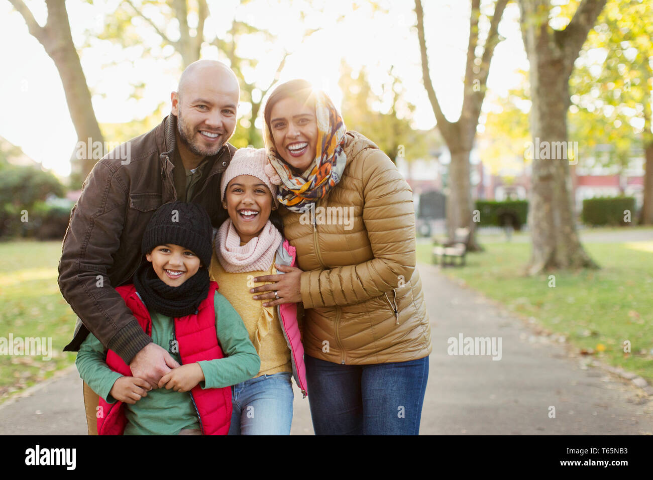 Portrait happy Muslim family in autumn park Stock Photo