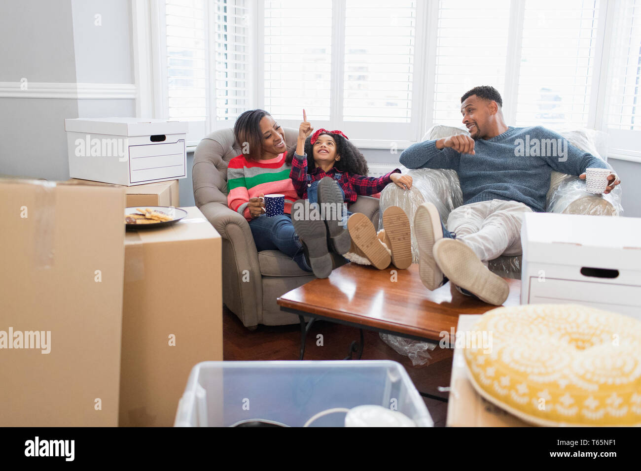 Family taking a break from moving house Stock Photo