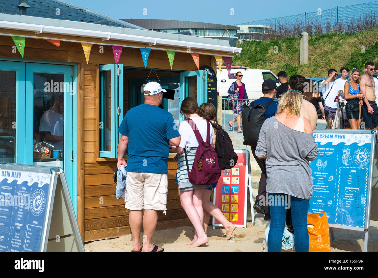 Holidaymakers queueing for ice cream at Fistral in Newquay in Cornwall. Stock Photo