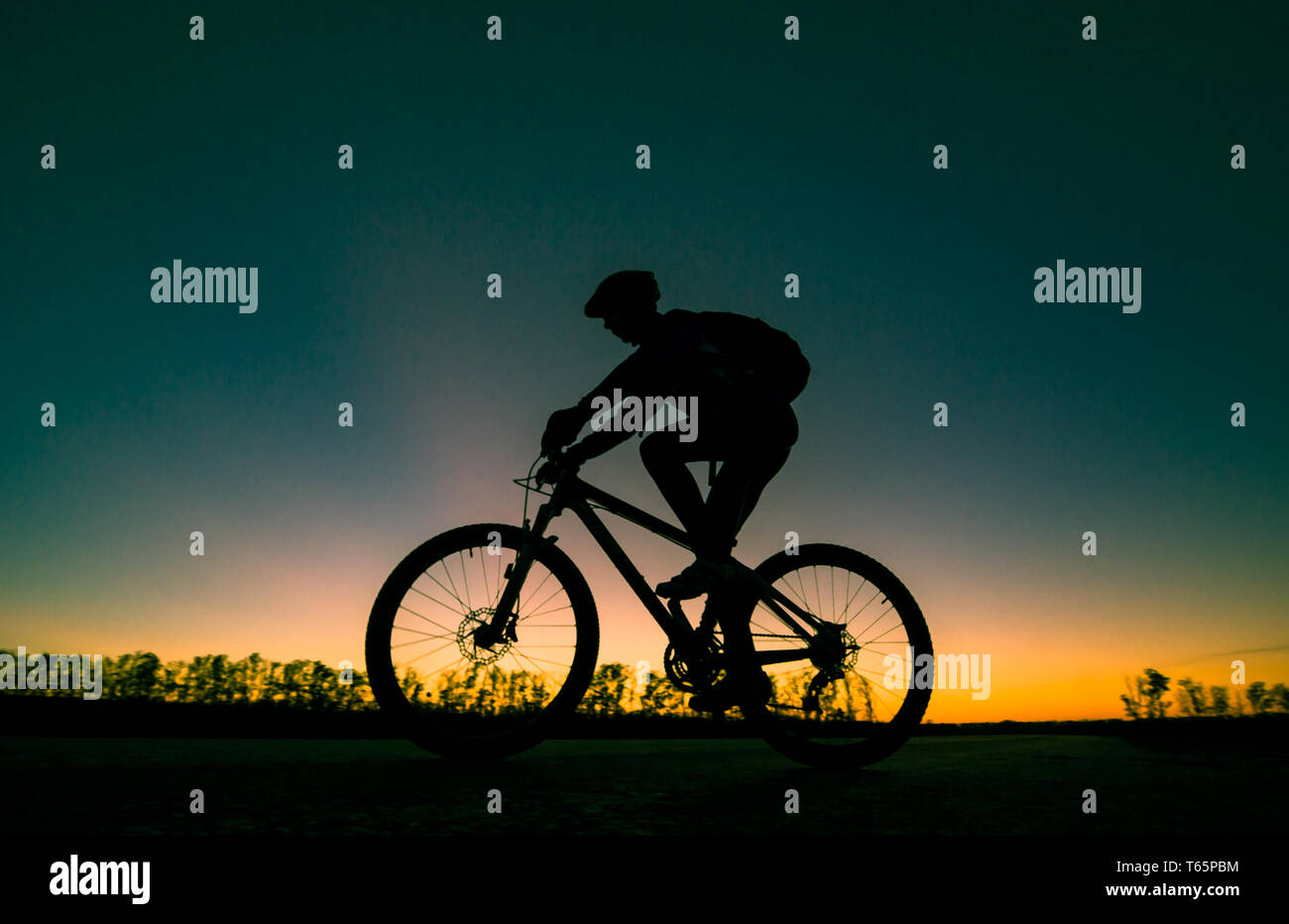 Silhouette Of Biker At Sunset Stock Photo Alamy