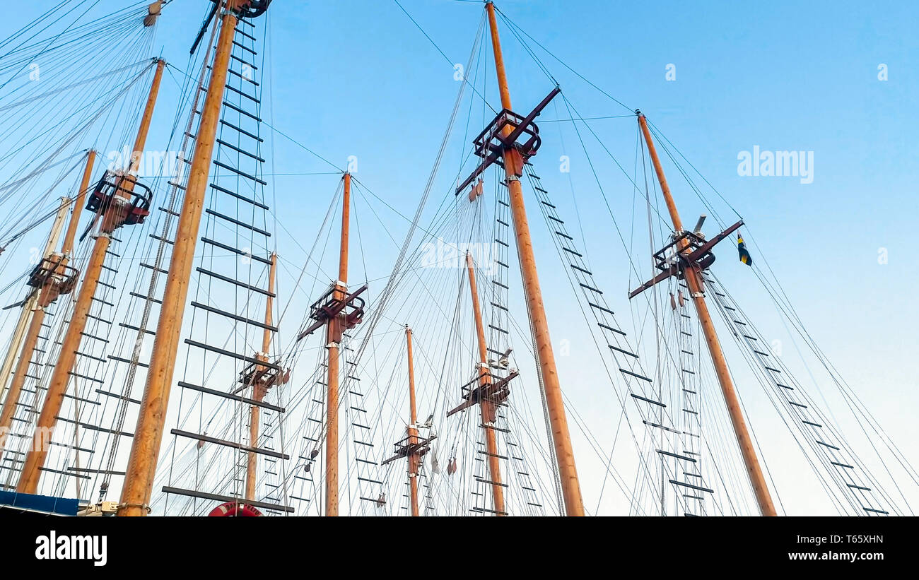 Wooden masts and historical ship rigging against blue sky Stock Photo ...