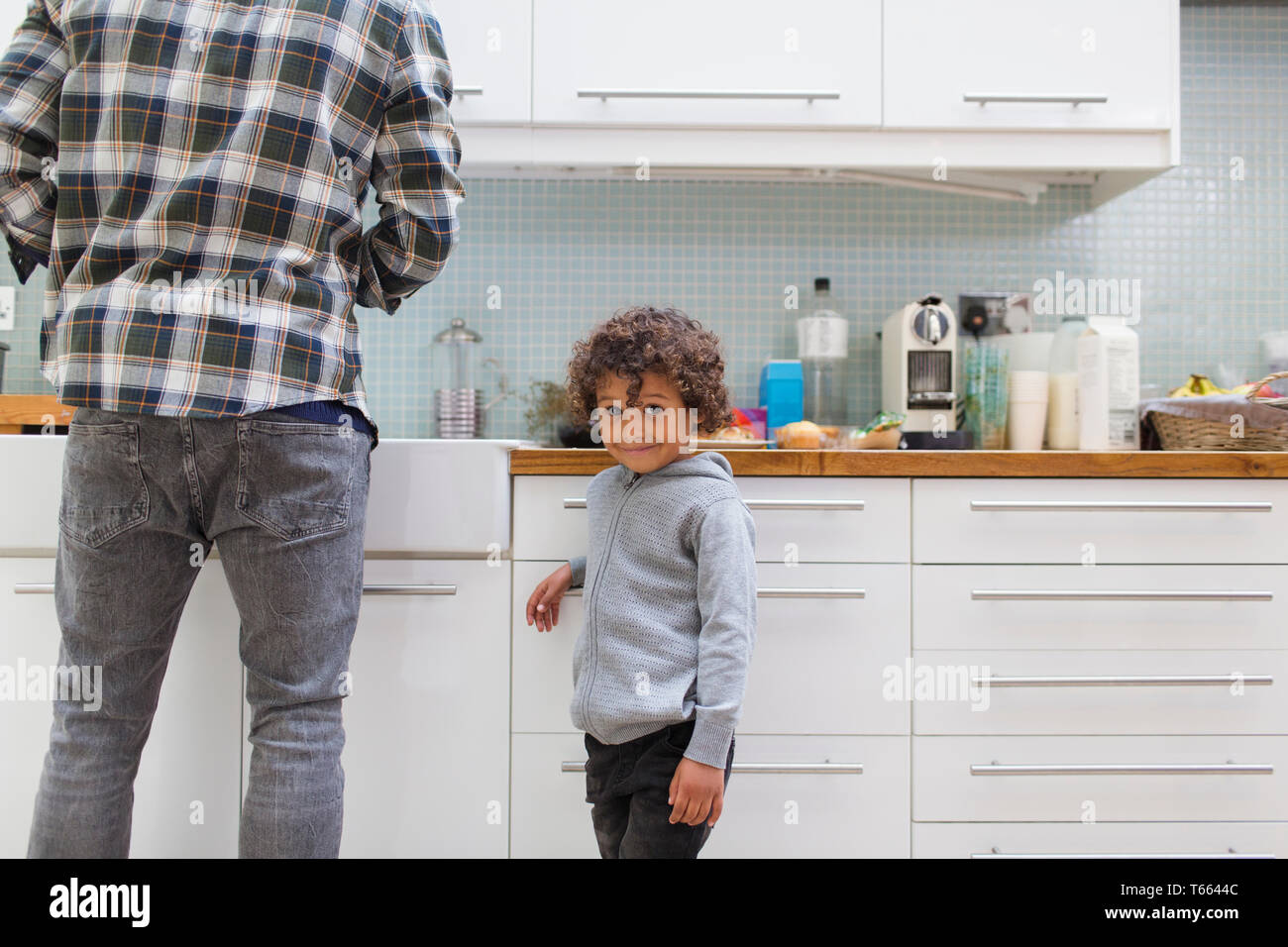Portrait cute boy in kitchen with father Stock Photo