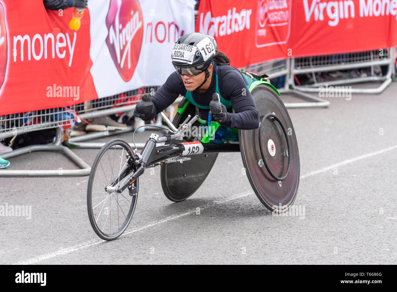 Aline dos Santos Rocha racing in the Virgin Money London Marathon 2019 wheelchair race near Tower Bridge, London, UK Stock Photo