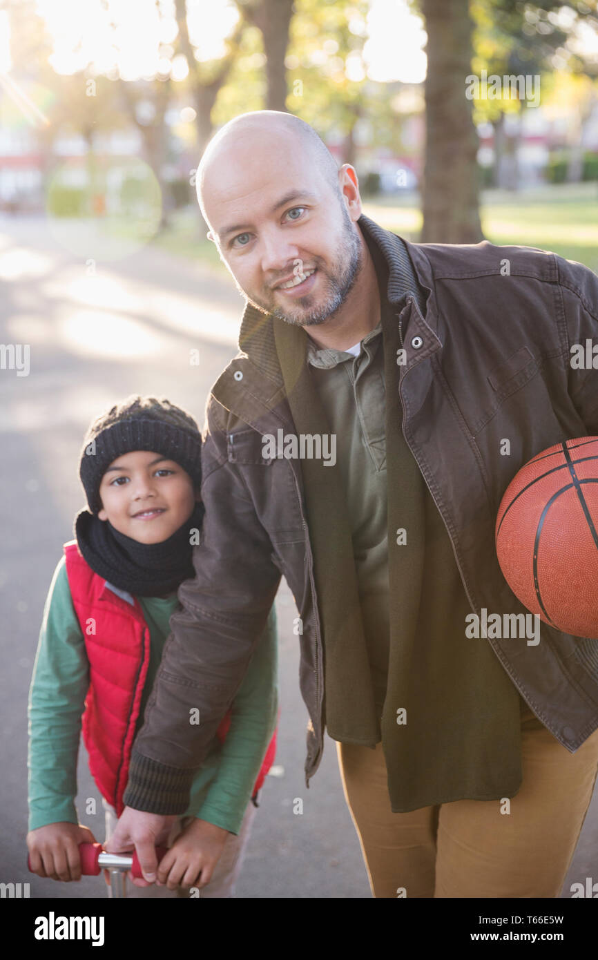 Portrait father and son with basketball in autumn park Stock Photo - Alamy
