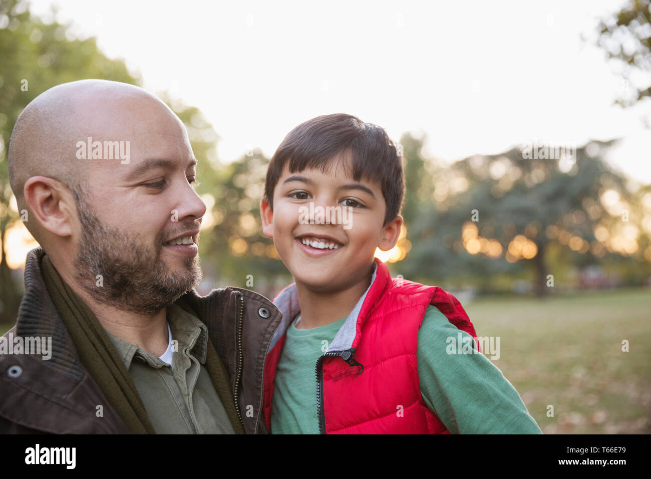 Portrait happy father and son in autumn park Stock Photo - Alamy