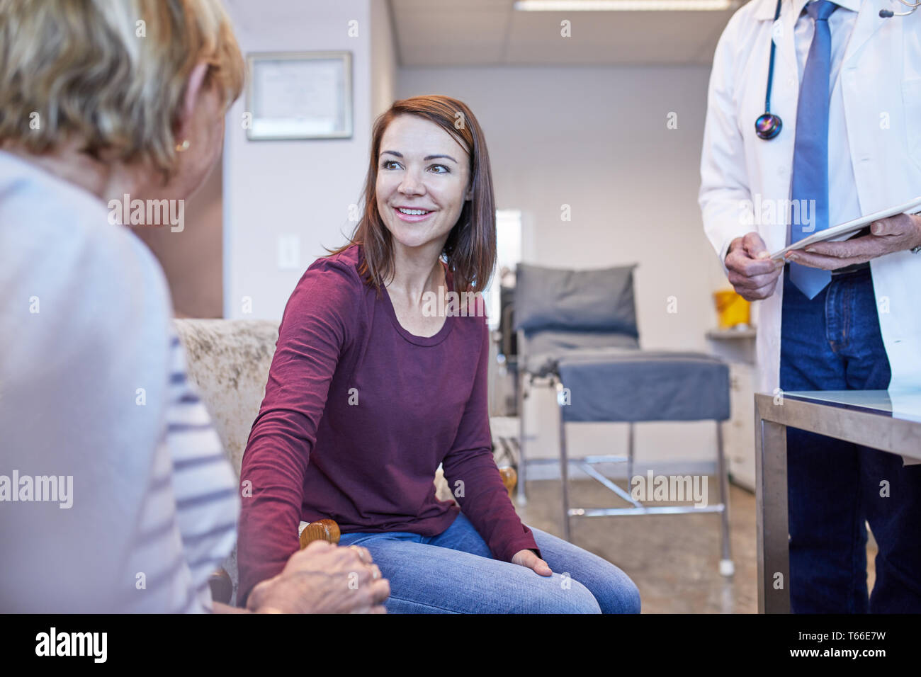 Doctor talking with patients in doctors office Stock Photo