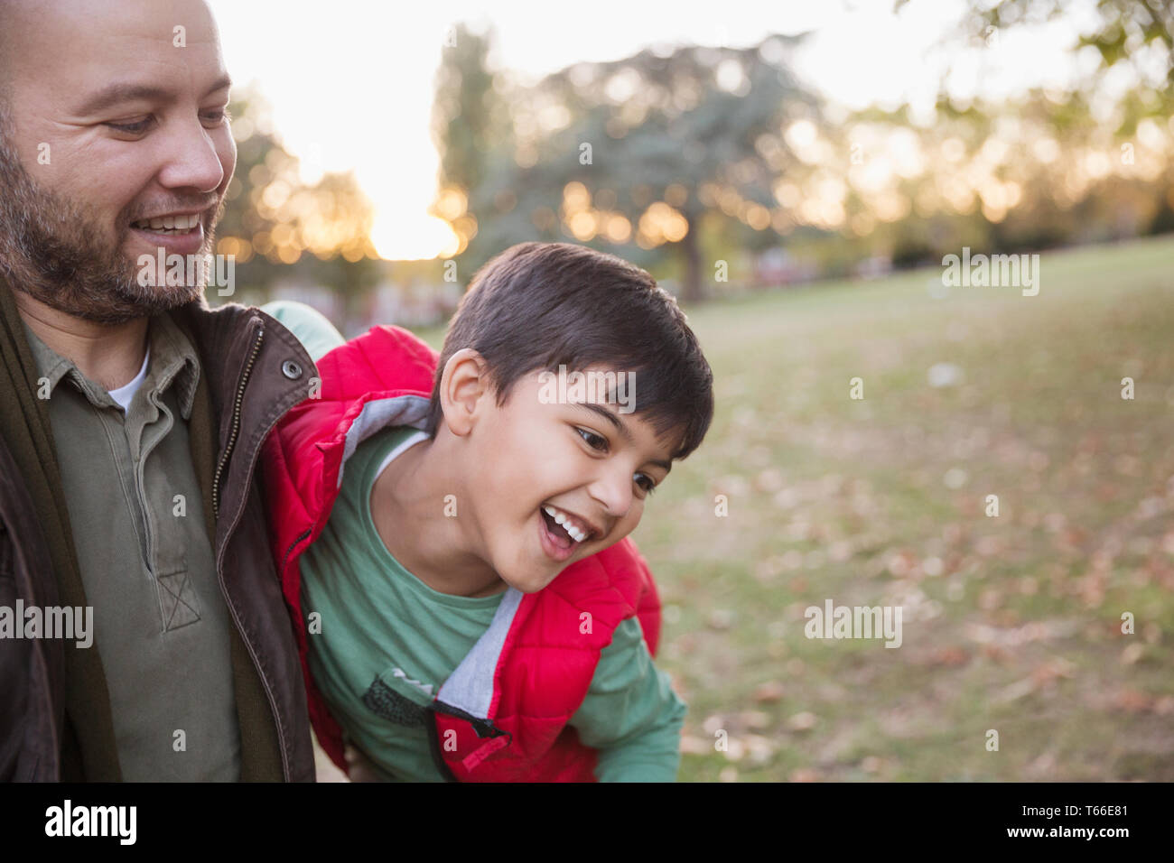 Happy father and son playing in autumn park Stock Photo - Alamy