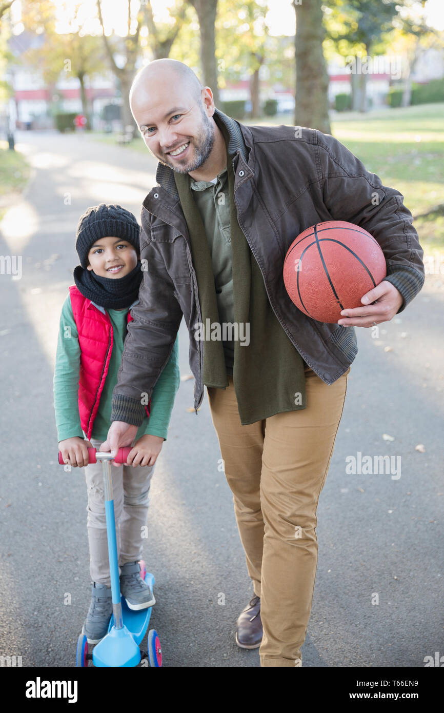 Portrait happy father and son playing in autumn park Stock Photo - Alamy