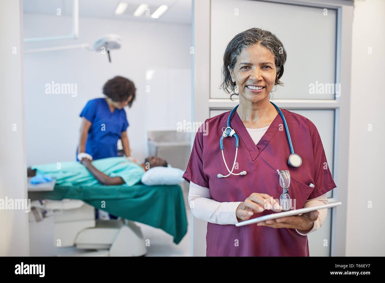 Portrait confident female doctor working in clinic Stock Photo