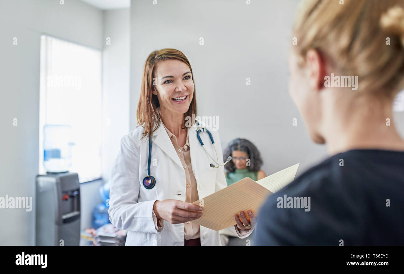 Female doctor and nurse talking in clinic Stock Photo