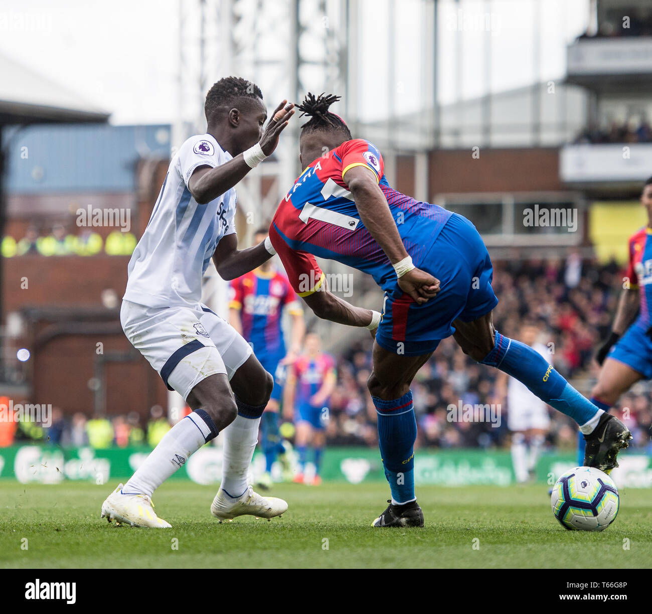 LONDON, ENGLAND - APRIL 27: Wilfried Zaha of Crystal Palace and Idrissa Gueye of Everton FC during the Premier League match between Crystal Palace and Everton FC at Selhurst Park on April 27, 2019 in London, United Kingdom. (Photo by Sebastian Frej/MB Media) Stock Photo
