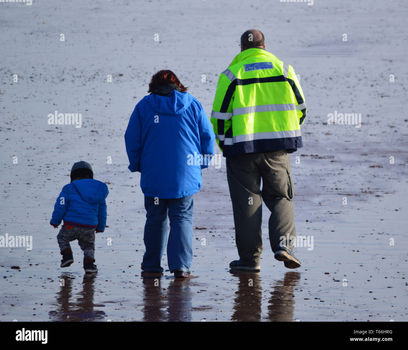 Beach walkers, mother, father and child Stock Photo