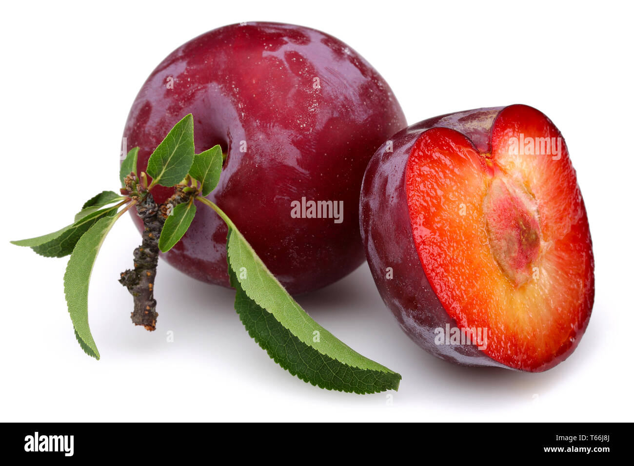 Red plums with leaves isolated on white background Stock Photo