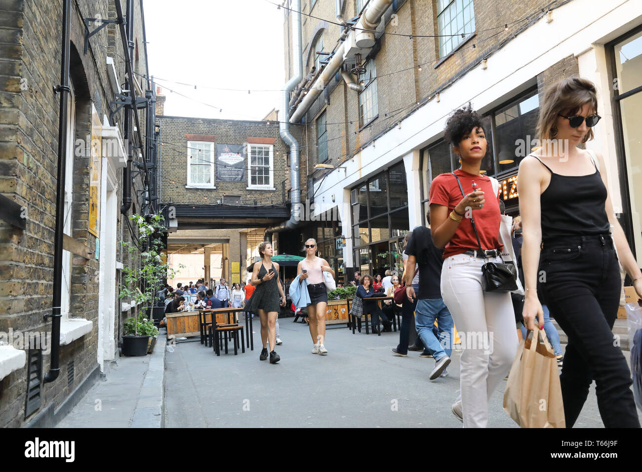 Restaurants on Dray Walk off vibrant Brick Lane Market in Tower Hamlets, in east London, UK Stock Photo