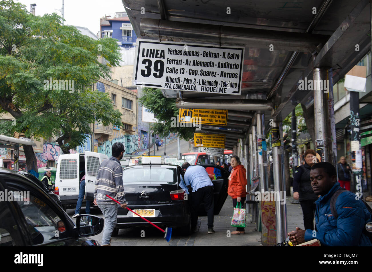 In Valparaiso, Chile, a busy downtown street where many suburban buses and shared taxis stop Stock Photo