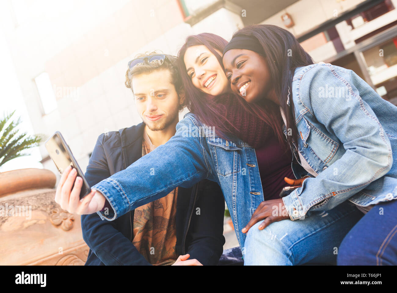Three friends take a selfie. Interracial friendship concept. Stock Photo