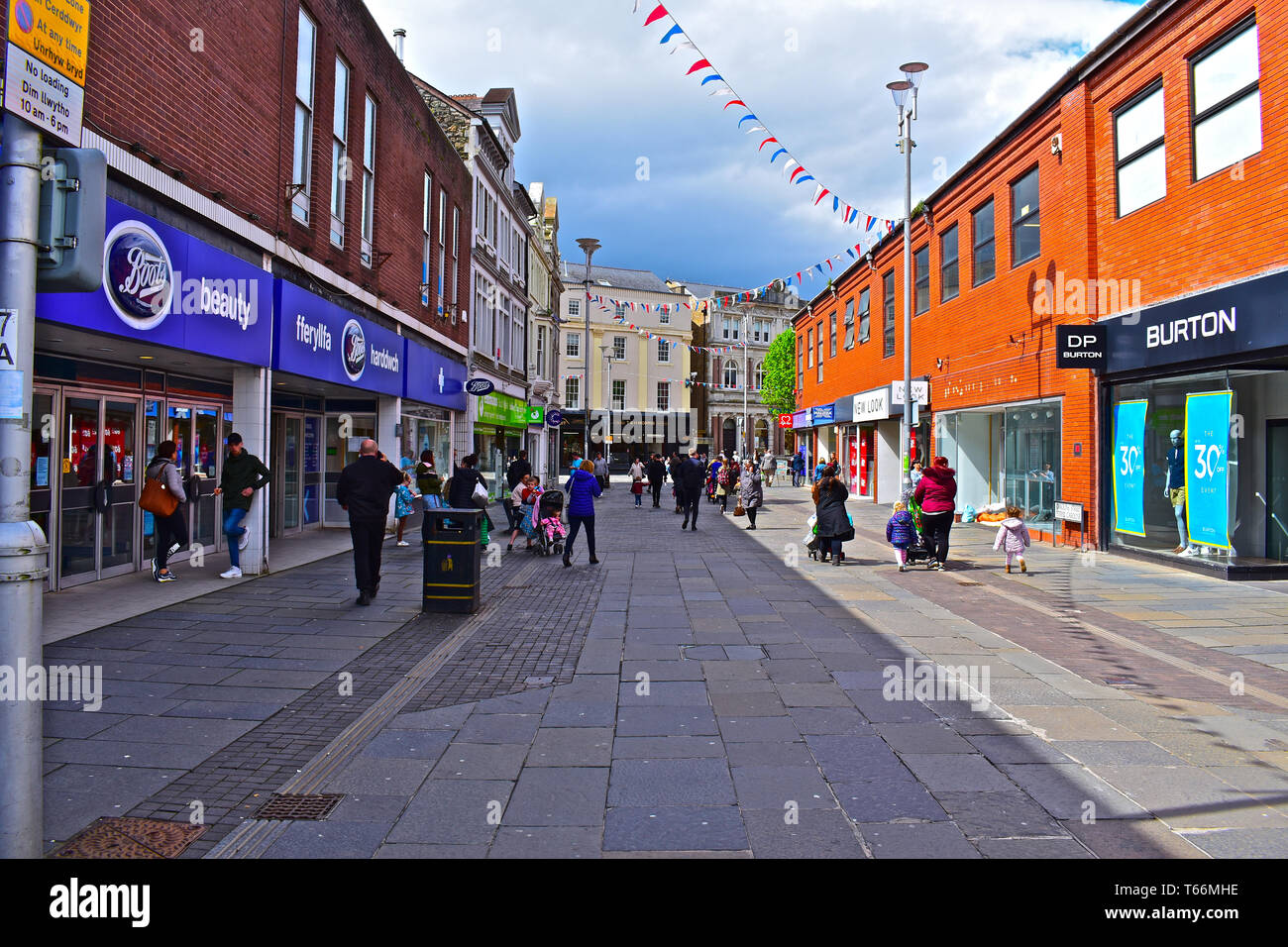 People walking along Caroline Street, one of the main shopping streets ...