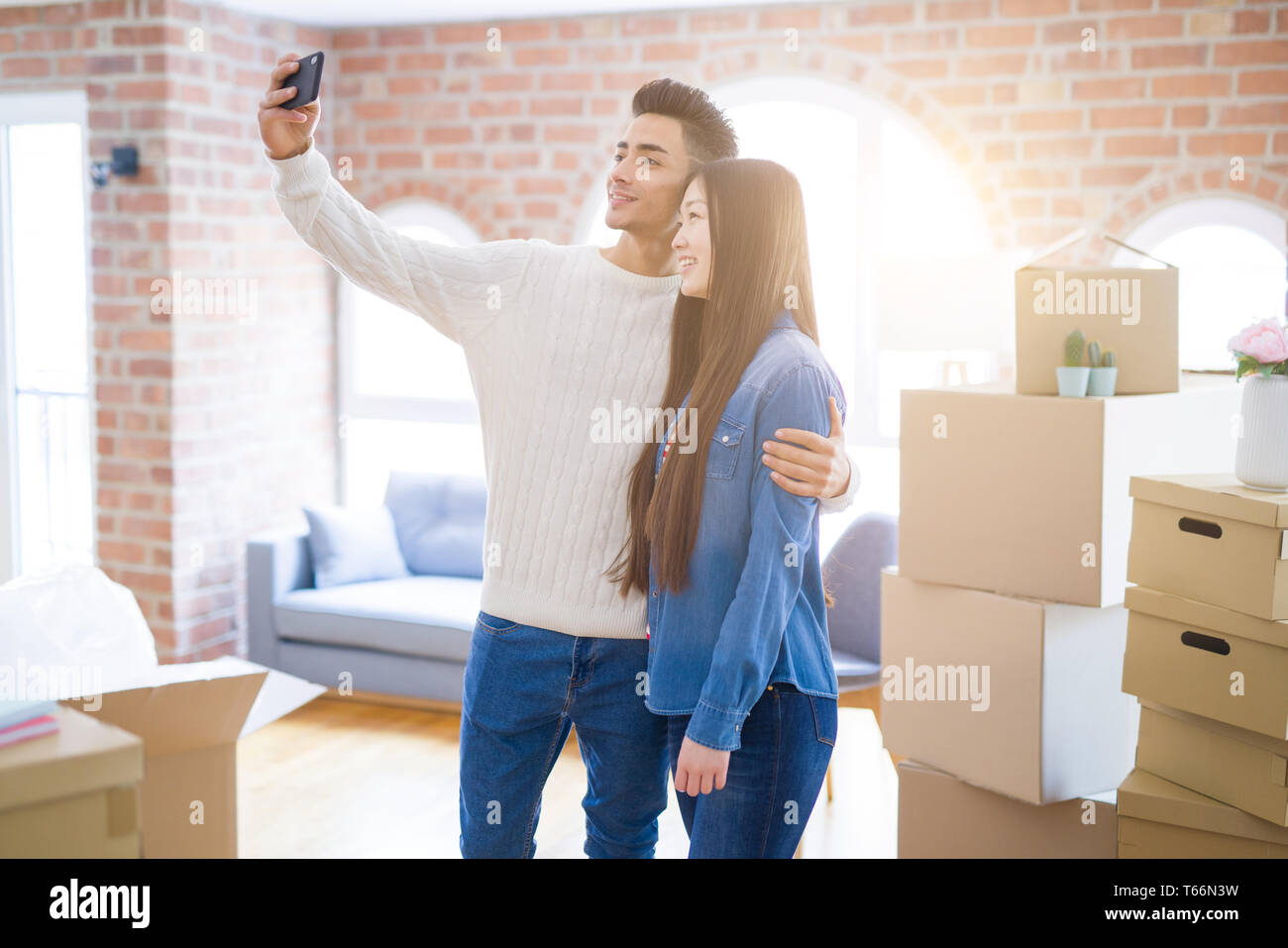 Young asian couple smiling taking a selfie photo with smartphone ...