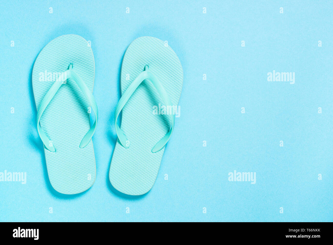 Blue flip flops on blue background Stock Photo - Alamy