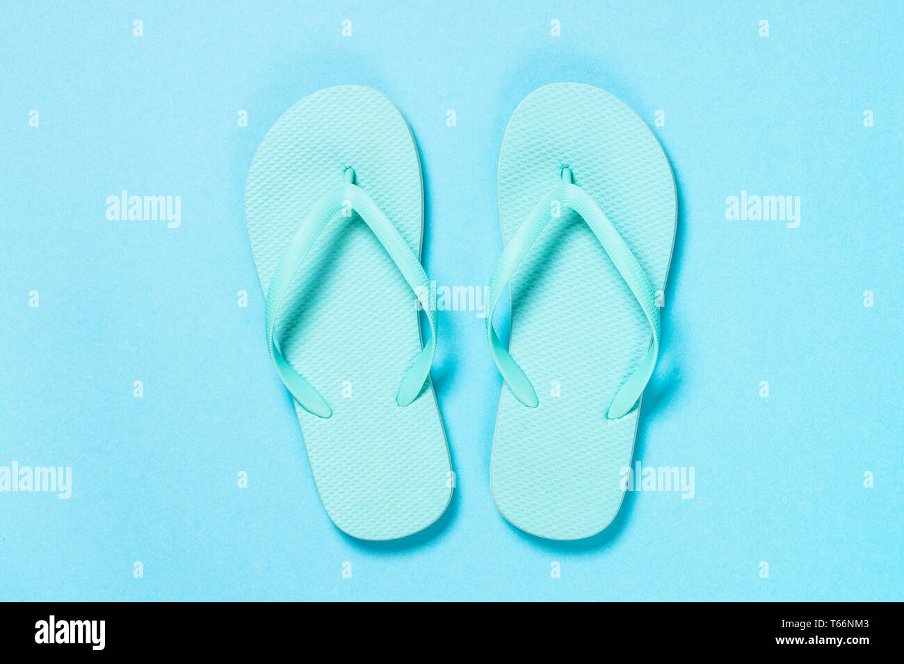 Blue flip flops on blue background Stock Photo - Alamy