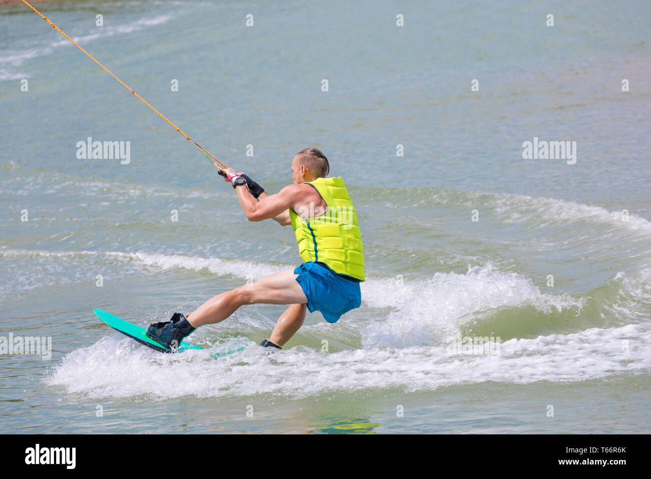 Man study wakeboarding on a blue lake Stock Photo