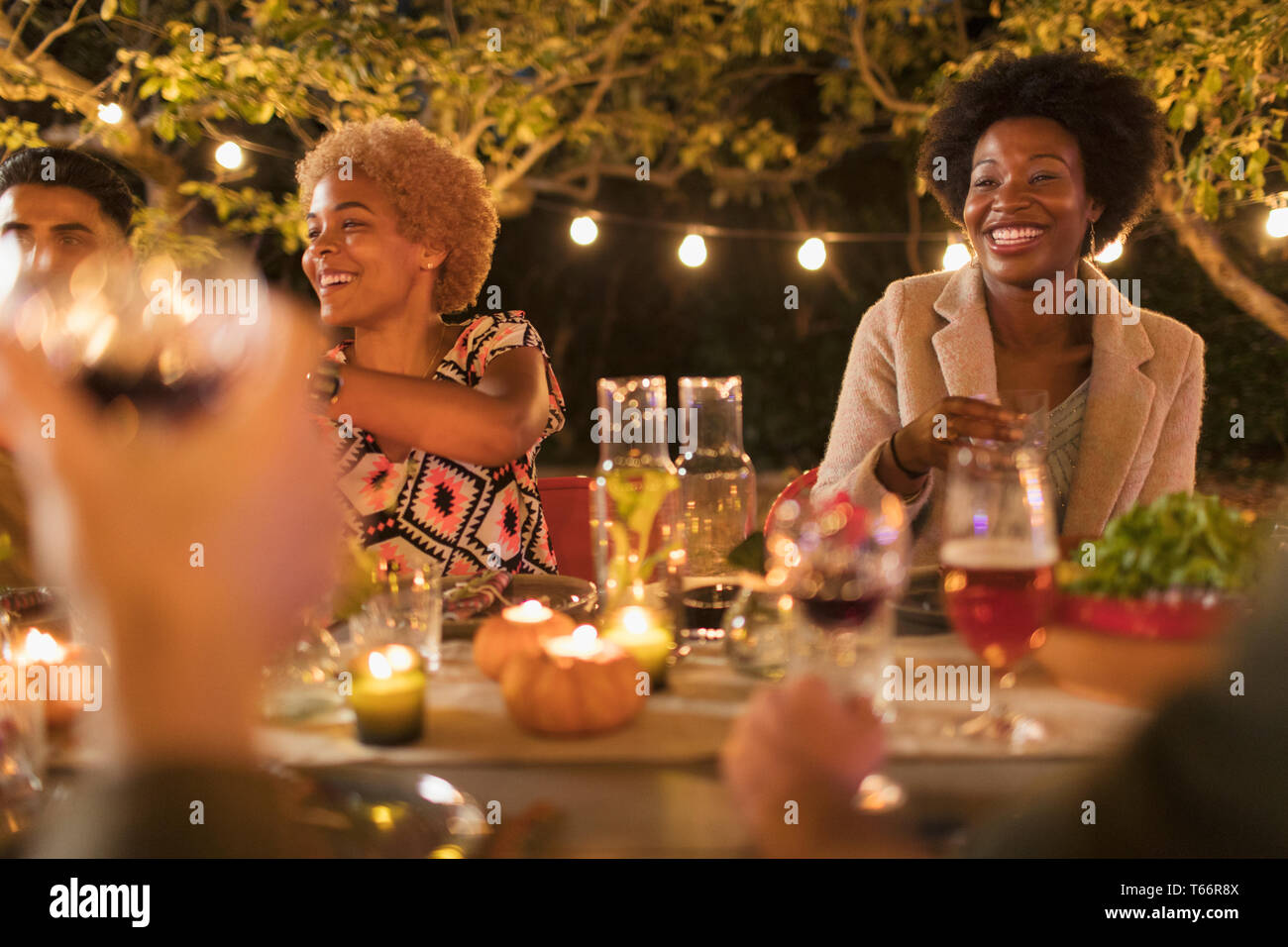 Happy friends enjoying dinner garden party Stock Photo