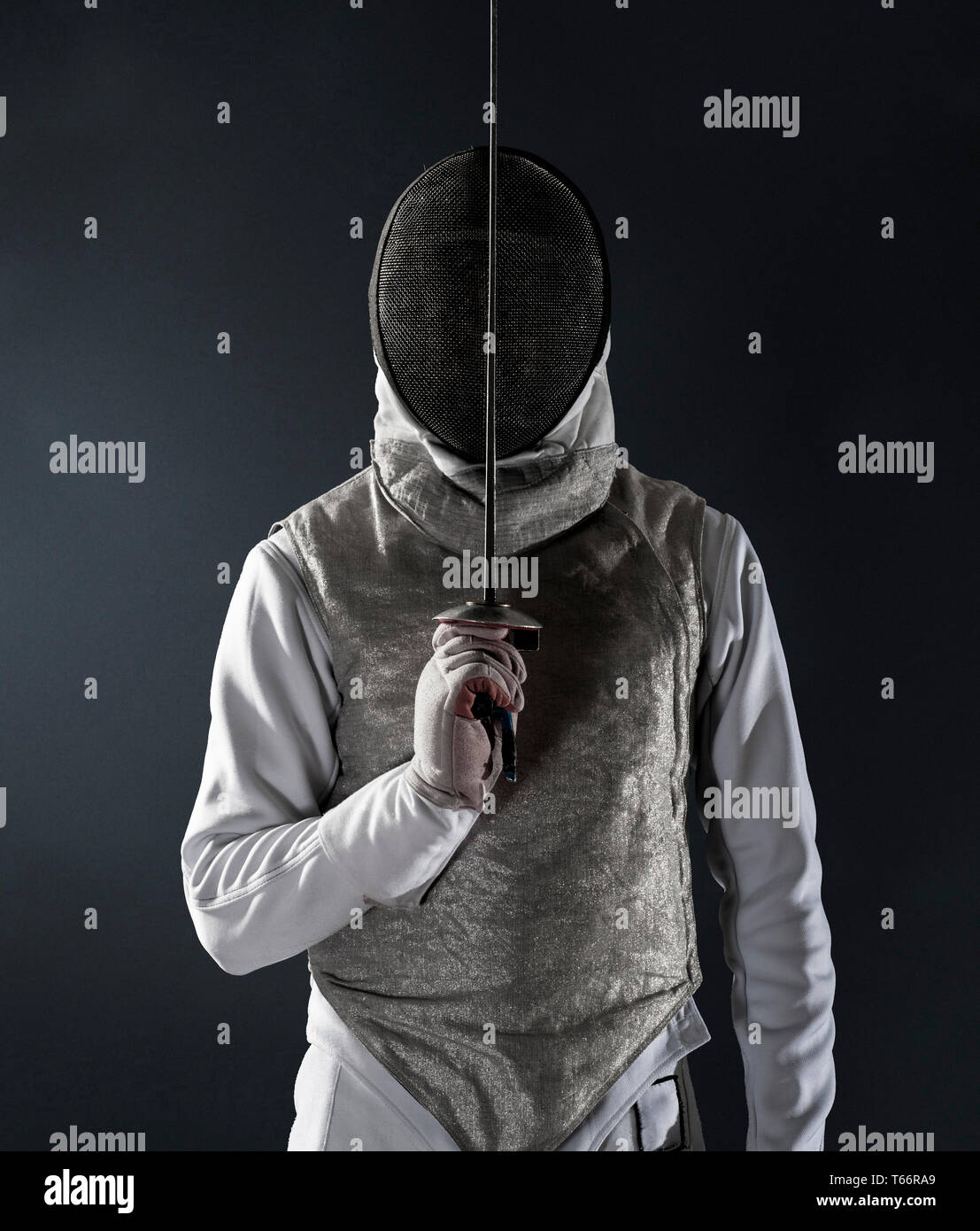 Portrait man in fencing uniform and mask Stock Photo