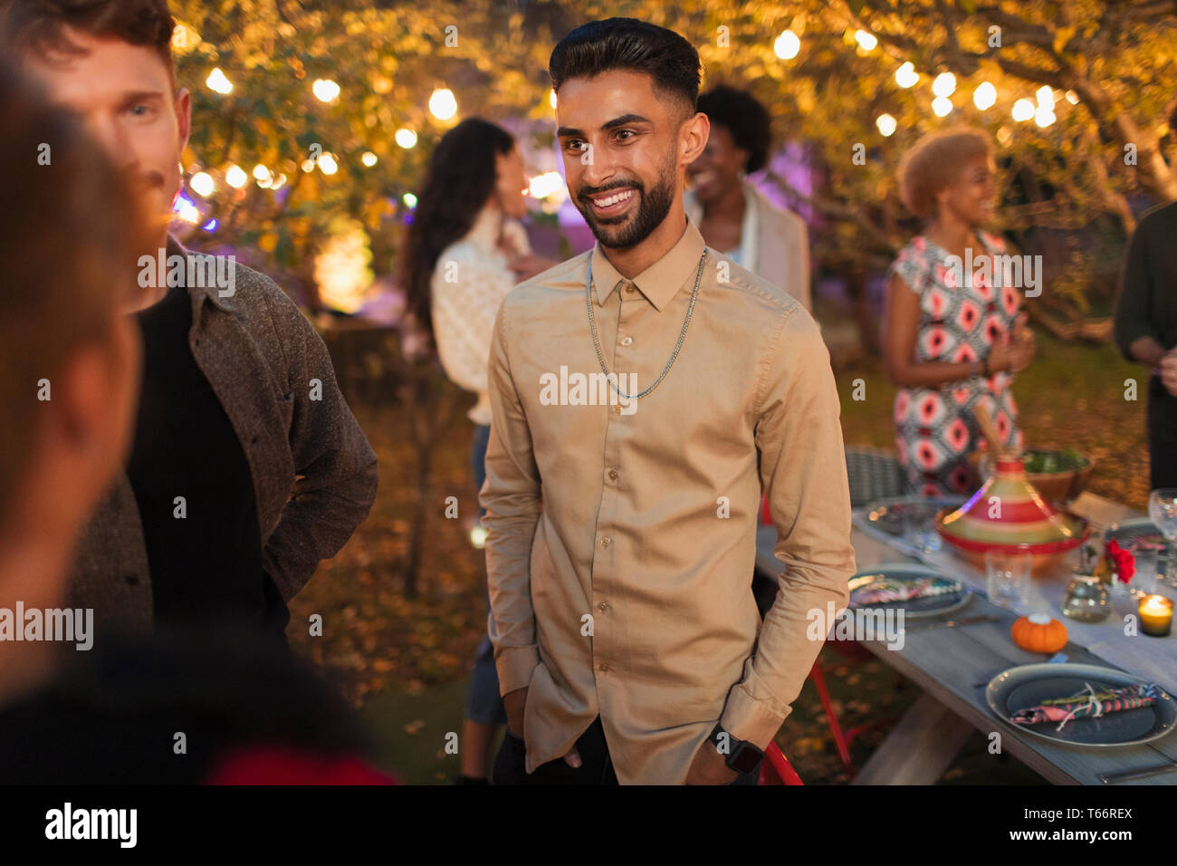 Friends talking at dinner garden party Stock Photo
