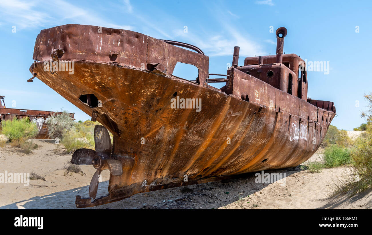 Rusting Shipwreck in the desert around Moynaq / Muynaq where the Aral Sea used to be. Uzbekistan. Stock Photo