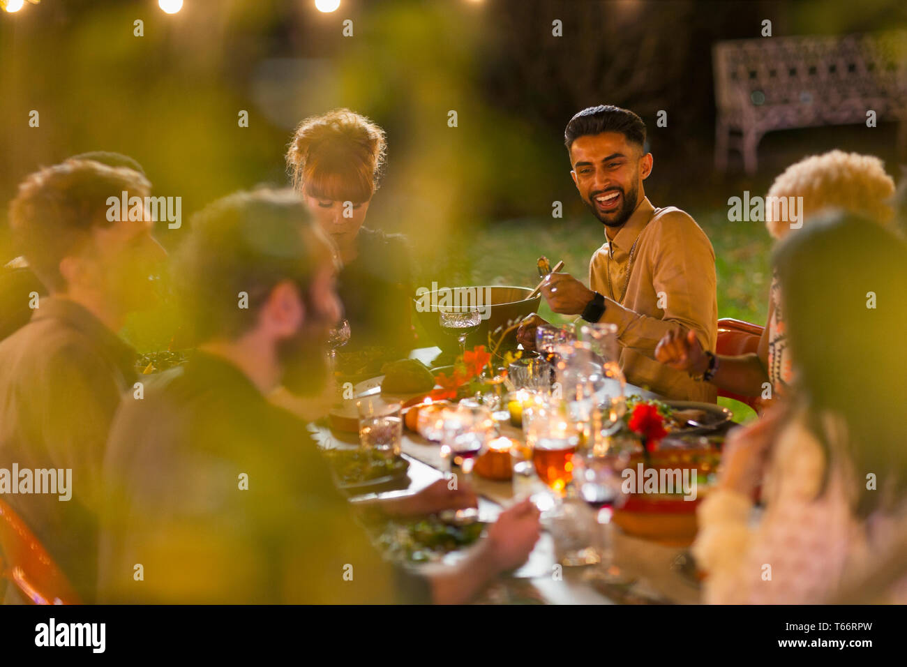 Happy friends enjoying dinner garden party Stock Photo