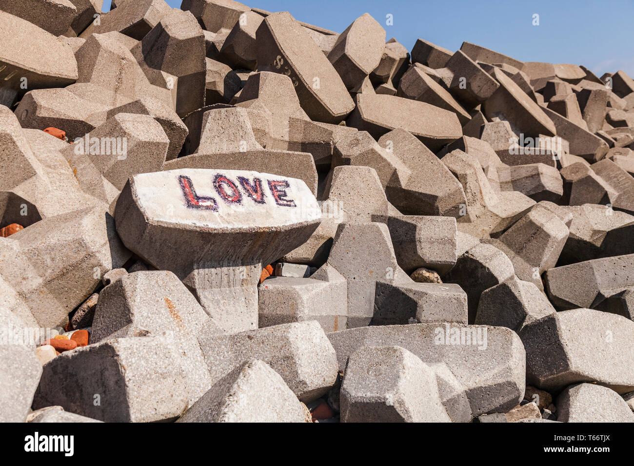 A concept of 'Love on the Rocks' at Hartlepool,England,UK with the word 'Love' daubed in graffitti on the rocks on the beach Stock Photo