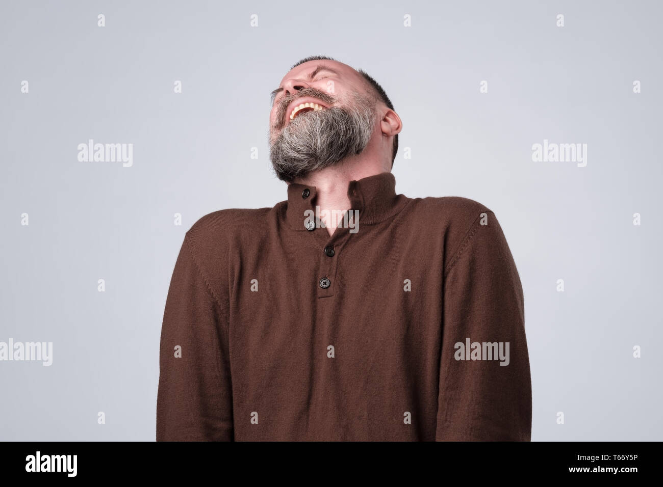 Caucasian mature man laughing on funny joke. Stock Photo