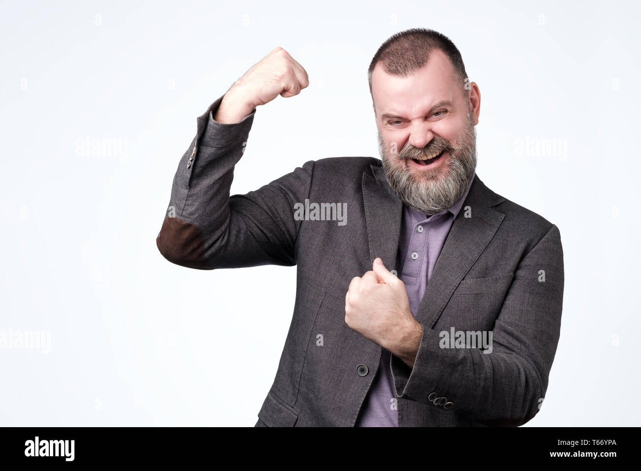 Positive mature guy showing his success boasting. Stock Photo