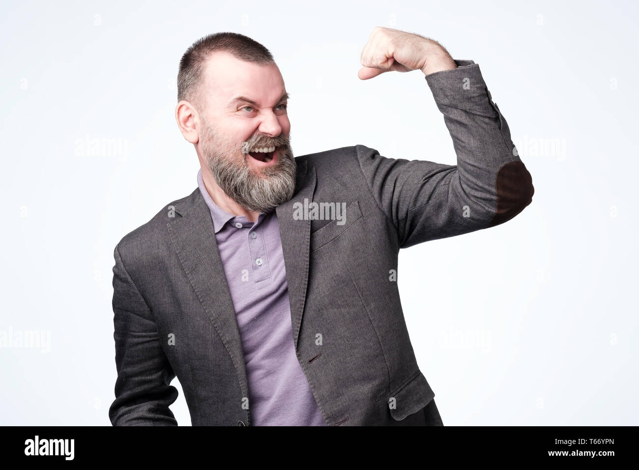 Positive mature guy showing his success boasting. Stock Photo