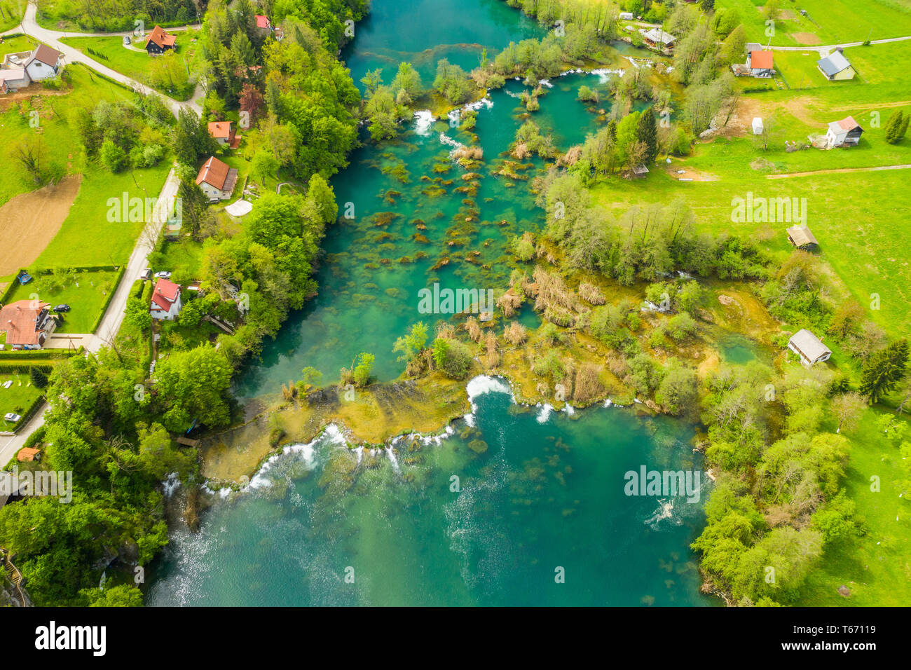 Croatian countryside landscape, beautiful green Mreznica river from air ...