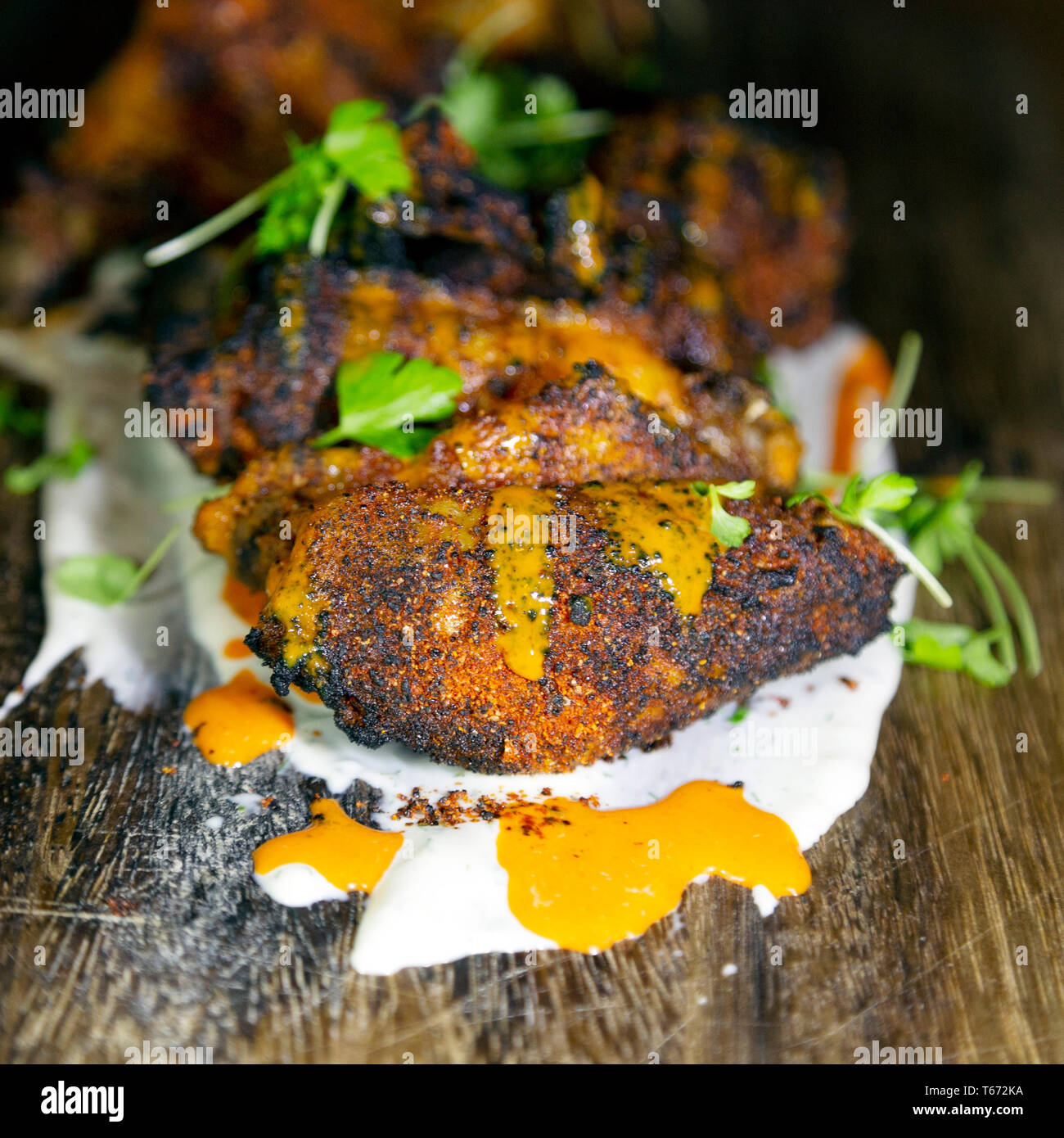Chicken wings served in Charleston, South Carolina, USA. The chicken has been marinaded prior to cooking. Stock Photo