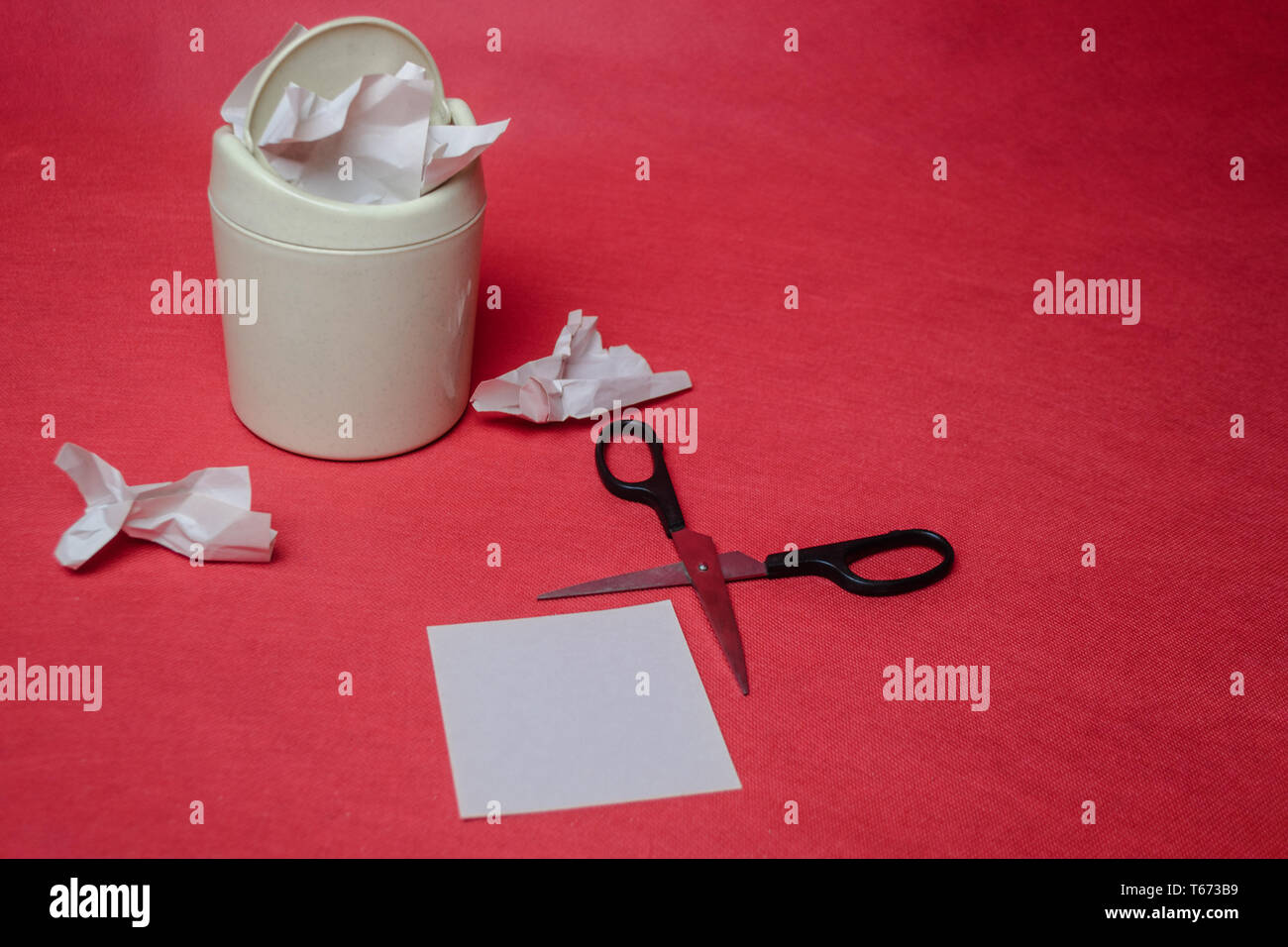 Light trash bin on a red background. Closeup of crumpled sheets of ...