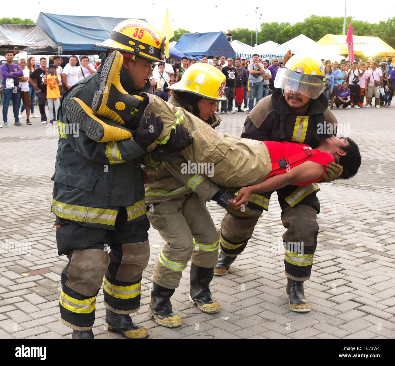 Participating firefighters are seen carrying a wounded patient during a