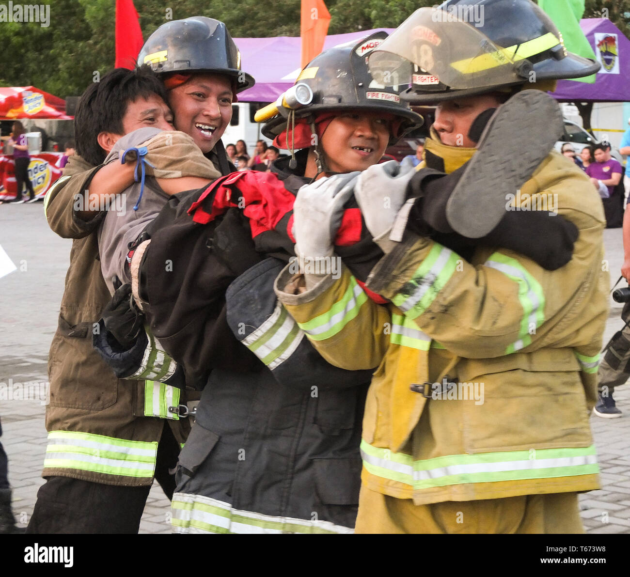 Participating firefighters are seen carrying a wounded patient during a