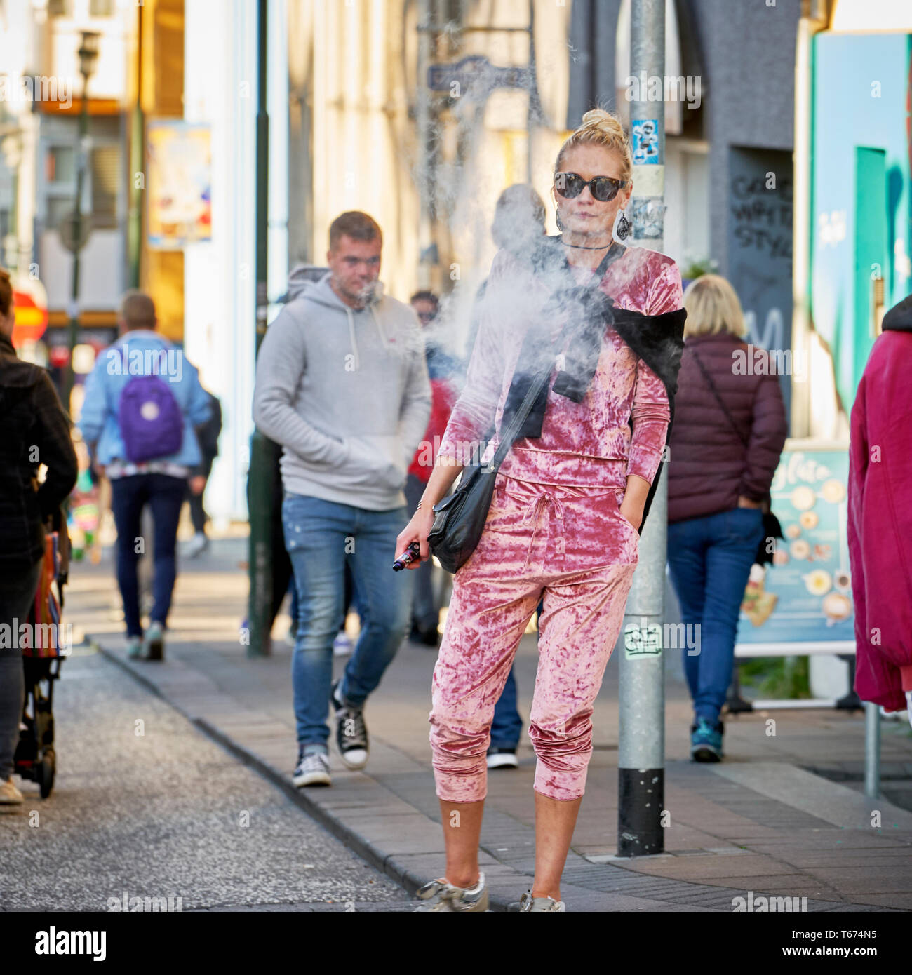 Woman smoking a vape pipe,  Cultural Day, Reykjavik, Iceland Stock Photo
