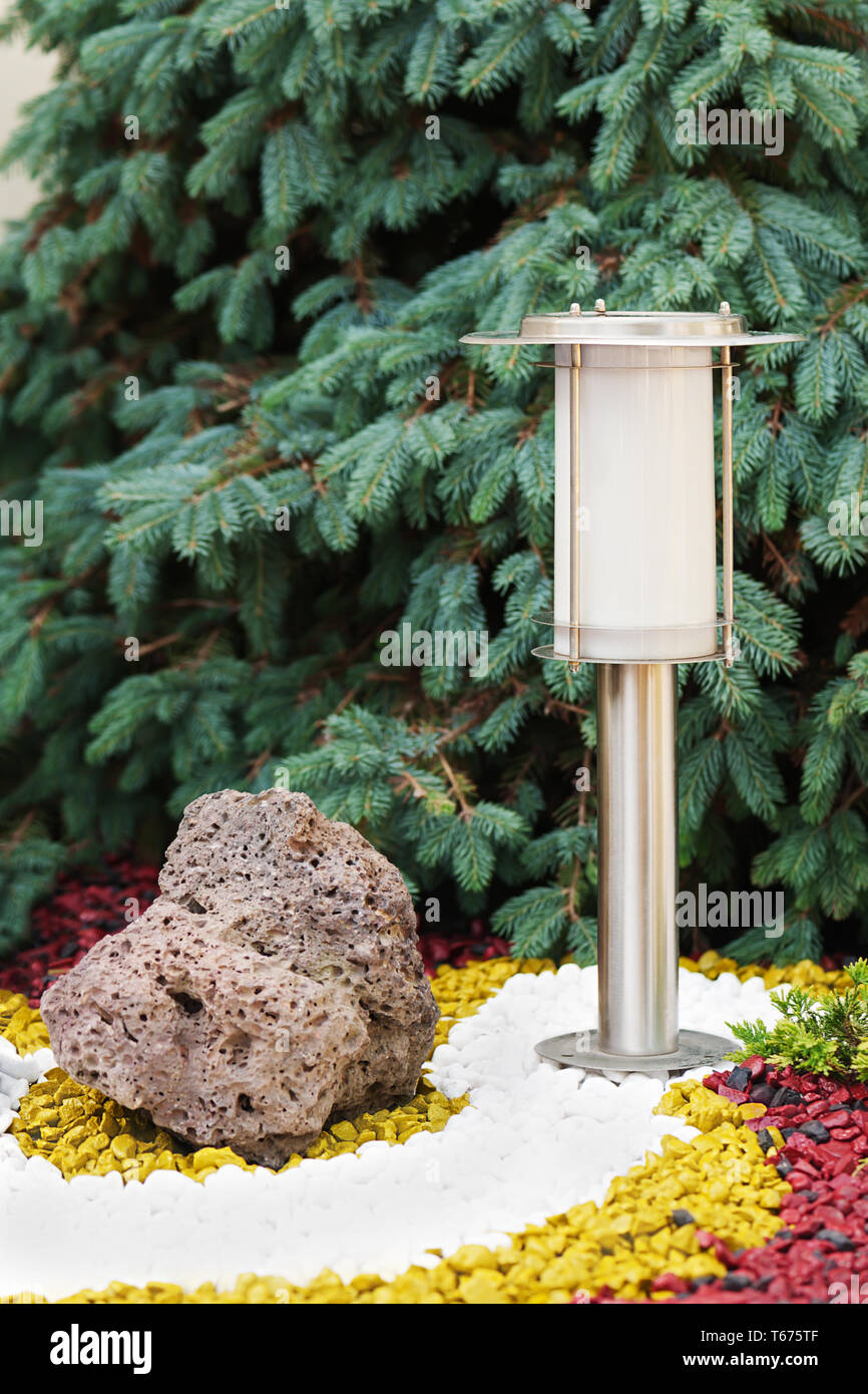 Solar-powered lamp on garden background. Selective Stock Photo