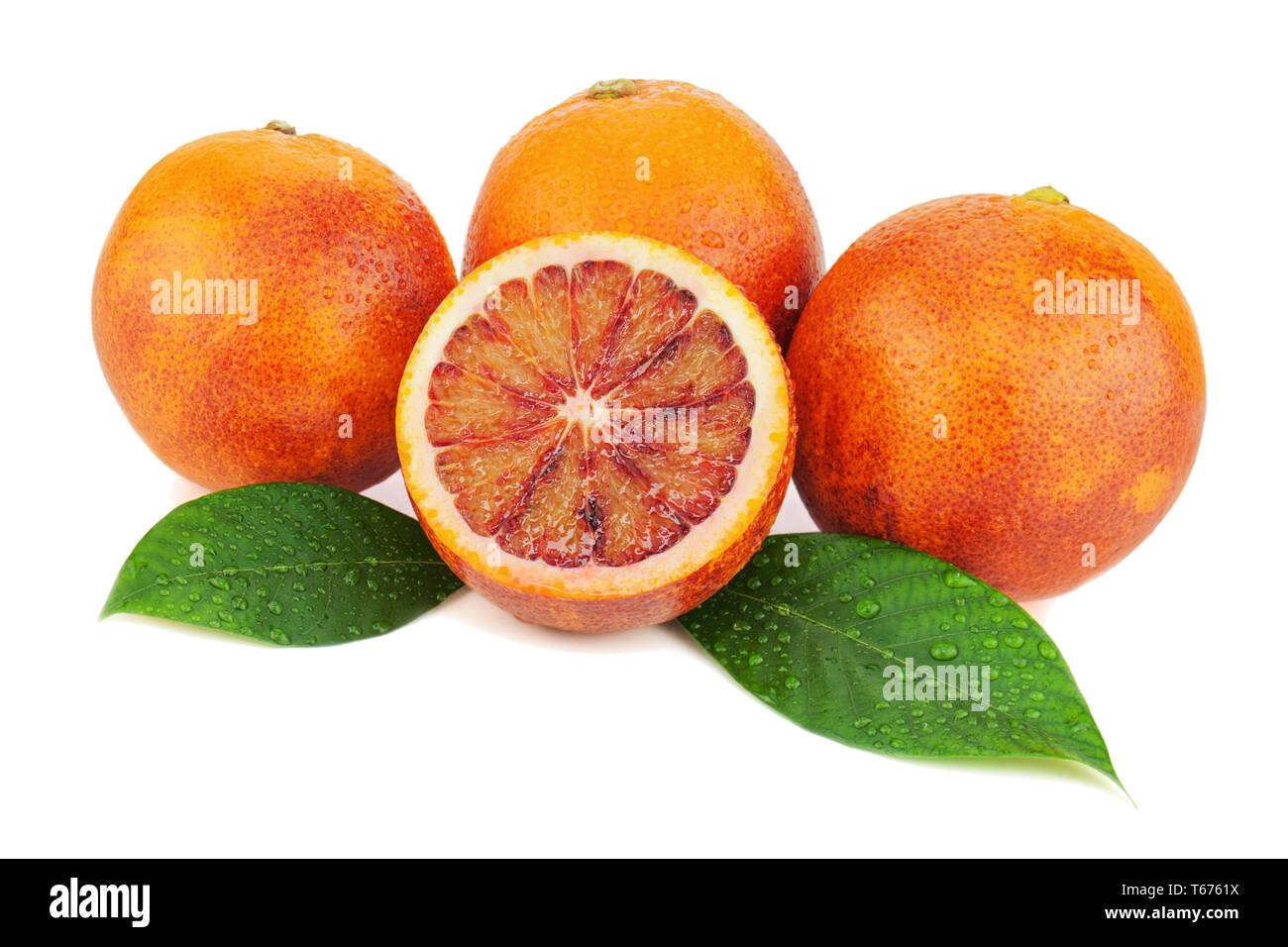 Ripe red blood oranges with cut and green leaves i Stock Photo