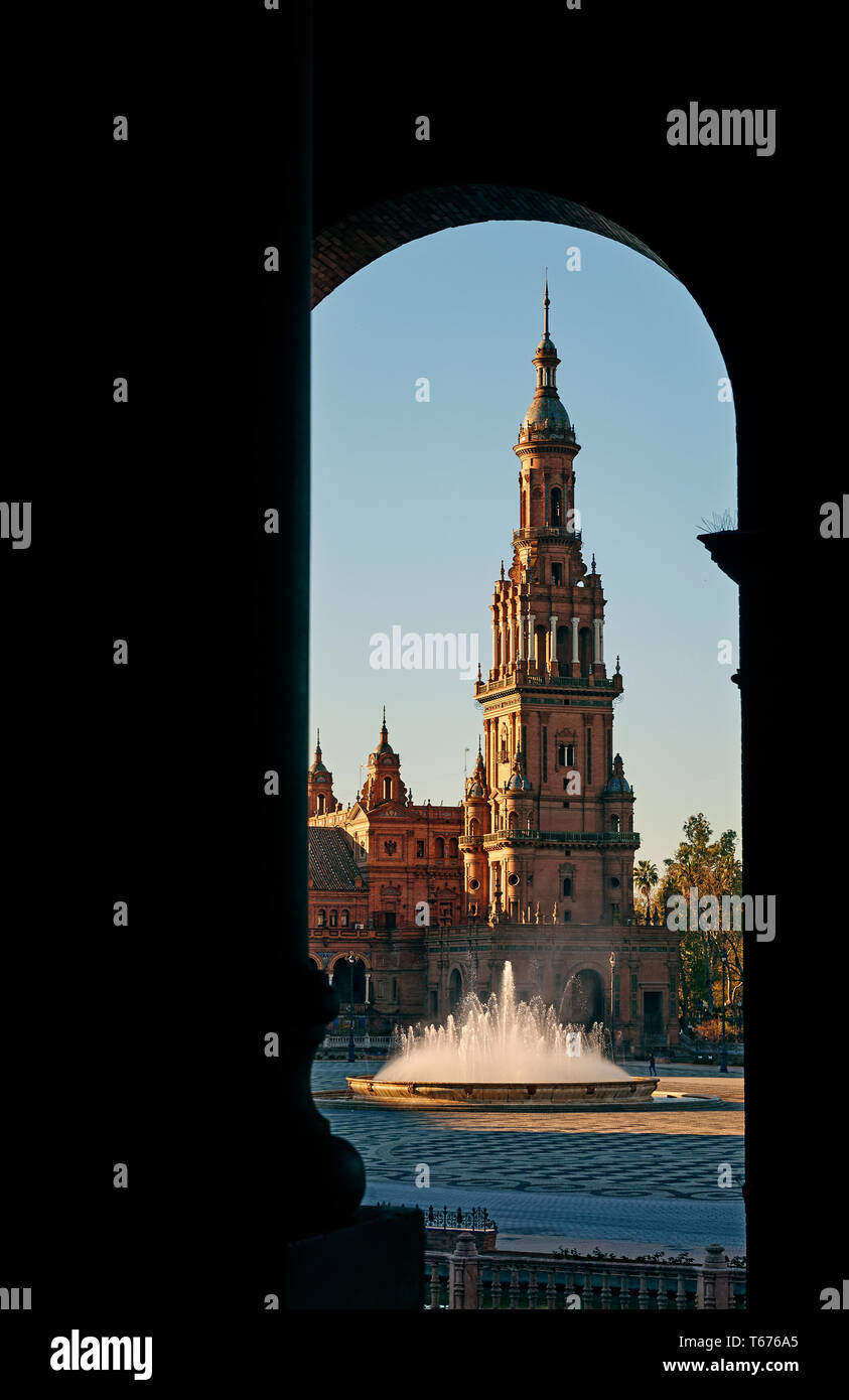 South Tower of the neo rennaissance 'Plaza de Espana' through arch in Seville at sunrise Stock Photo