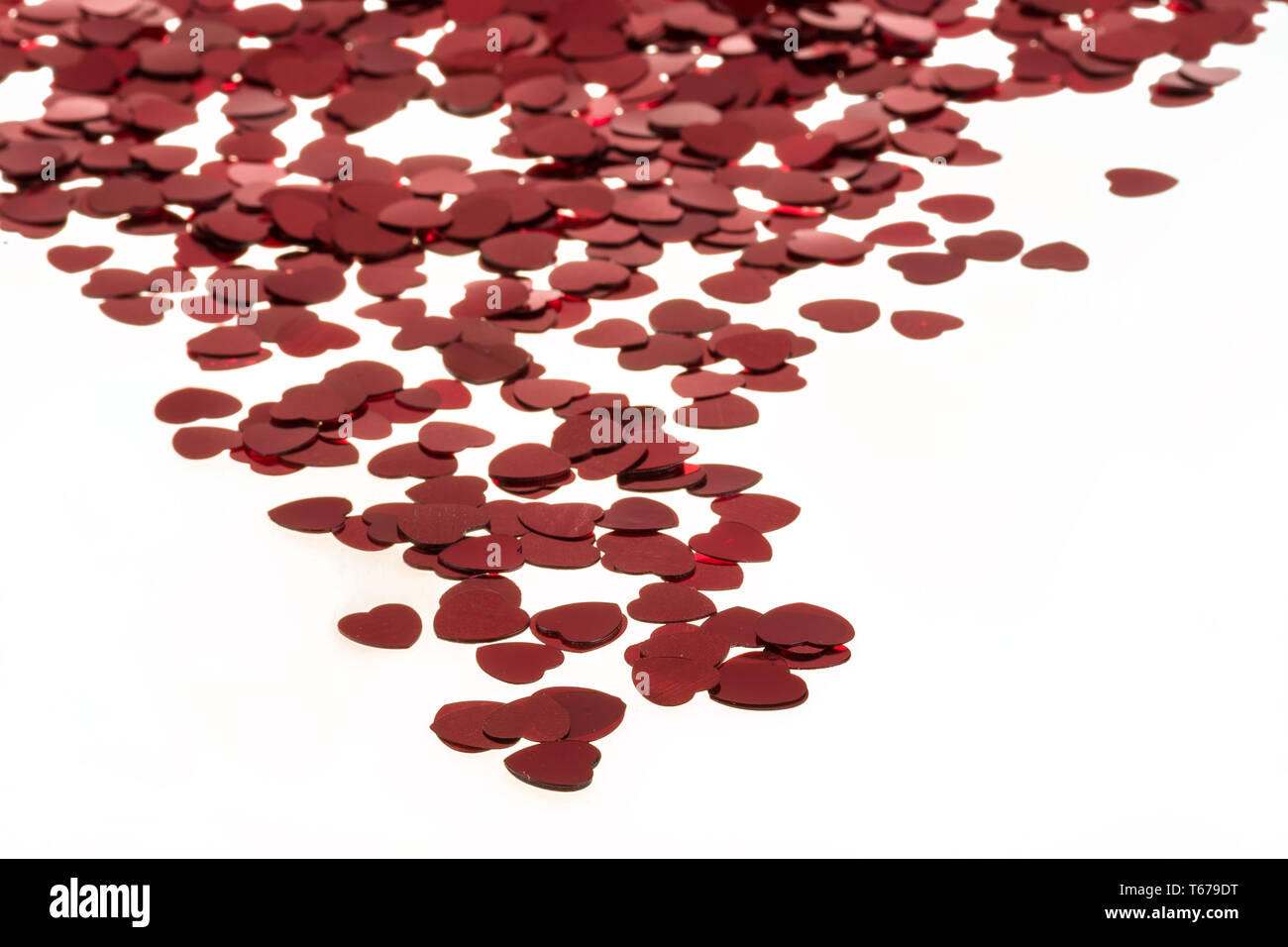 Red hearts confetti on white background Stock Photo - Alamy