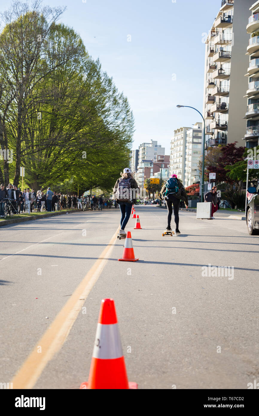 VANCOUVER, BC, CANADA - APR 20, 2019: Skateboards going down Beach Ave near the 420 Festival. Stock Photo