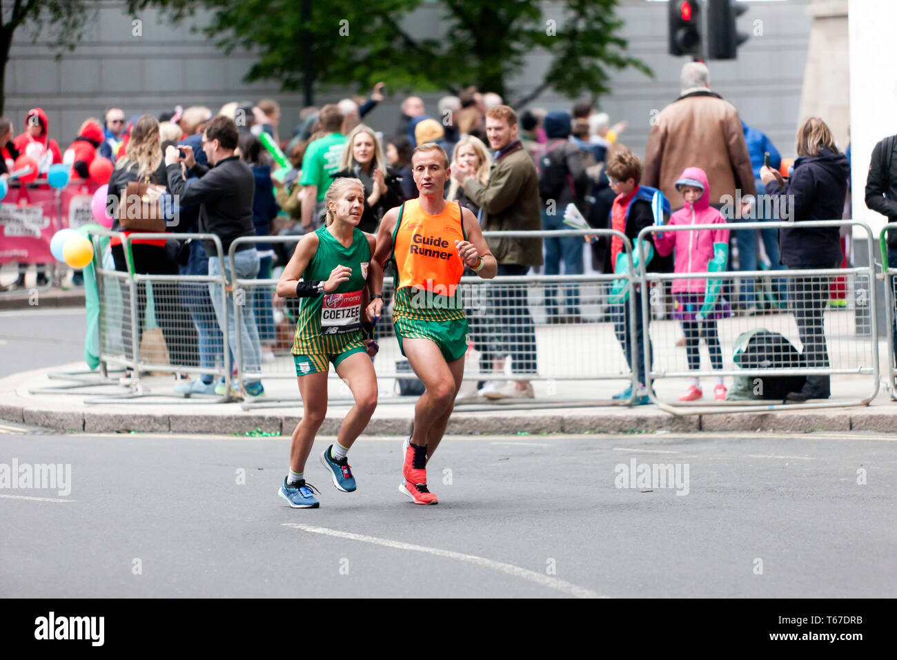 Louzanne Coetzee with her guide runner, competing in the 2019 London Marathon. Louzanne went on to finish 9th in the T11/12 Category, in a time of 03:33:22. Stock Photo