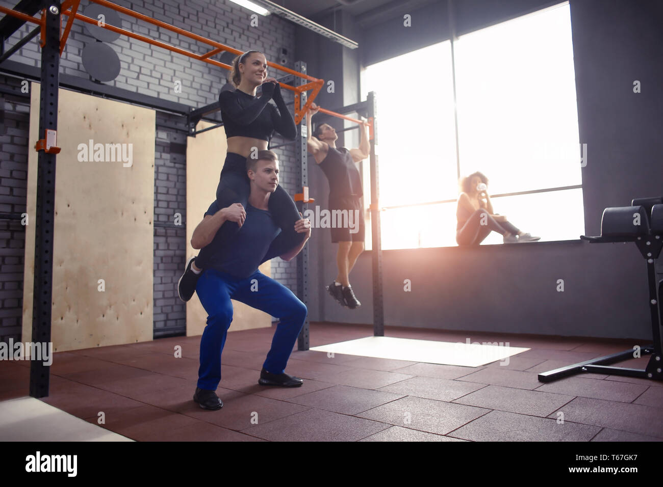 Young sporty couple training together in gym Stock Photo - Alamy