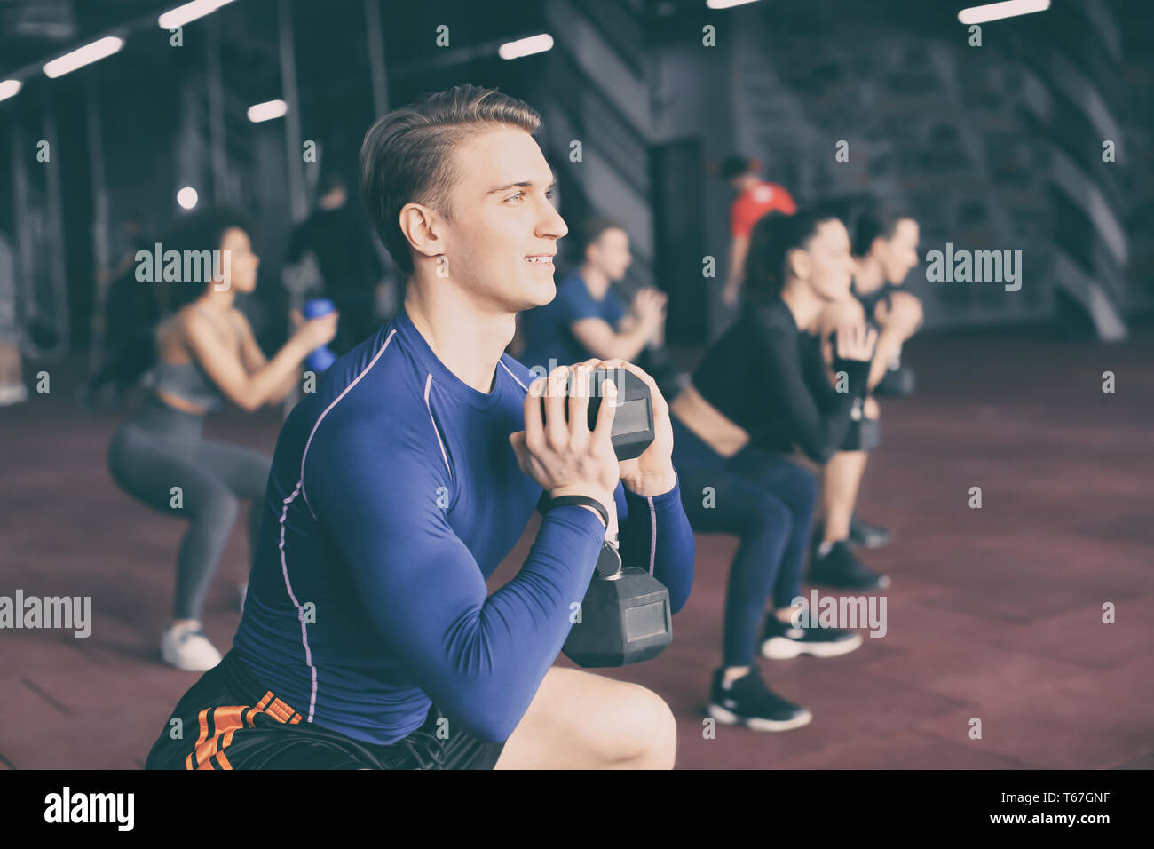 Group of athletes working out in gym Stock Photo