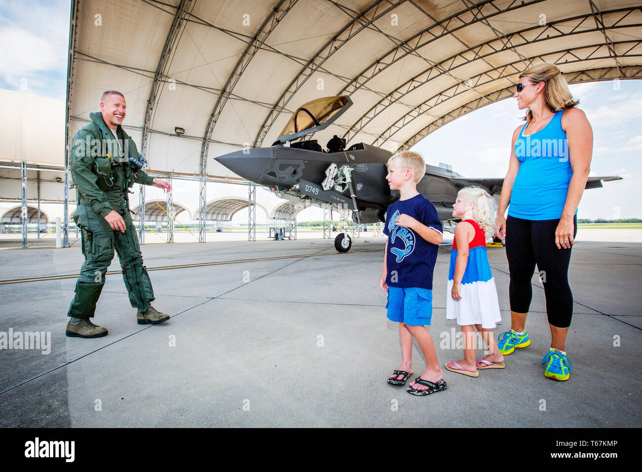 US Pilot Brad Turner is greeted by his wife Whitney , daughter Addison (4) and their son Chase (10) after a successful first mission in the new F-35 Fighter Jet at the Eglin Air Force Base. Stock Photo