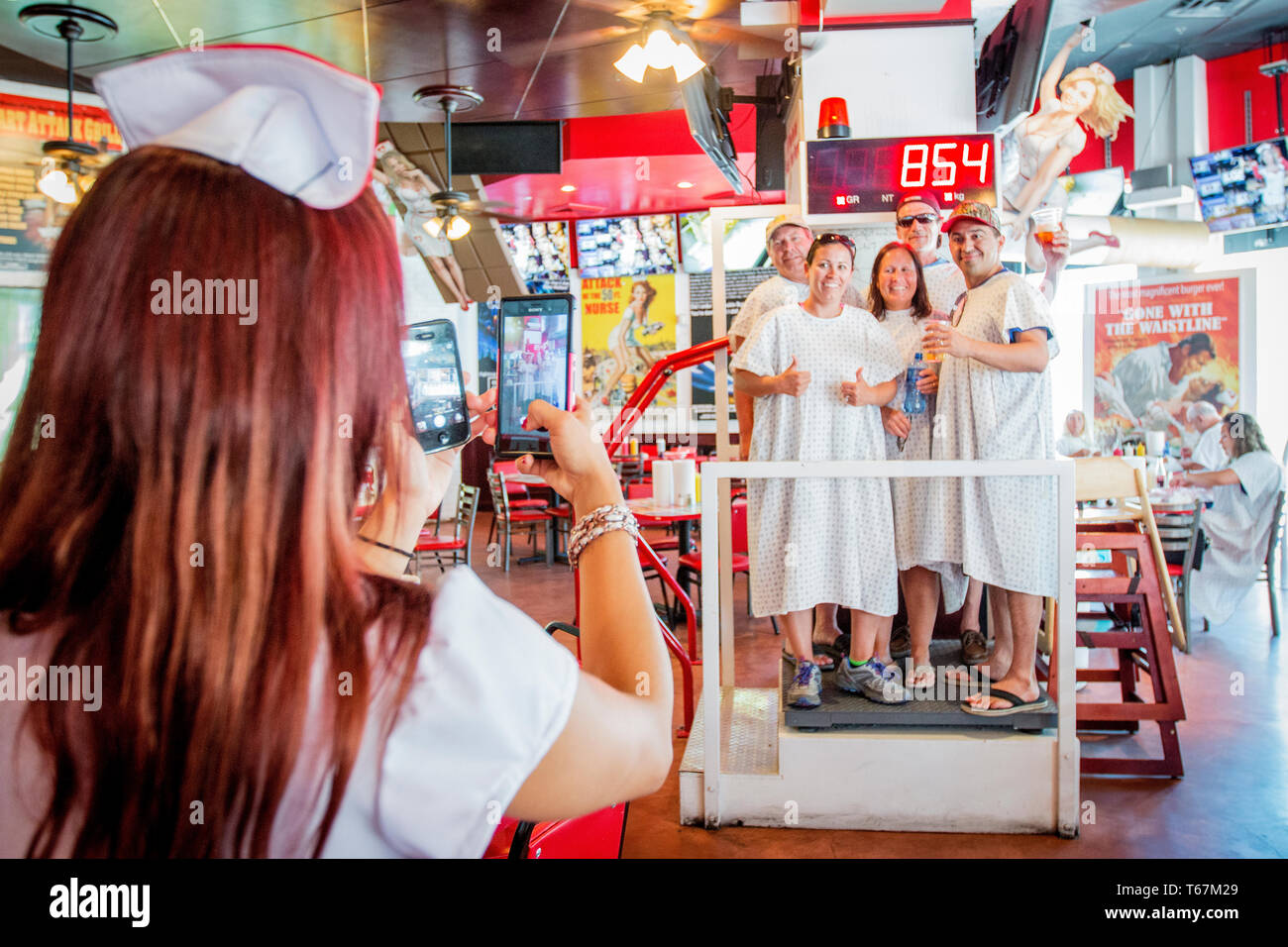 The Heart Attack Grill gladly serves up the infamous Octuple Bypass Cheeseburger with extra mayo and bacon. The hospital themed restaurant has become famous for putting the spotlight on unhealthy fastfood by serving and promoting the most obnoxious versions of the same. “Patients” weighing more than 350 pound eat for free, and nurses will spank you if you can’t finish your meal. The eight layered cheeseburger with mayo and bacon packs about 20.000 calories. Stock Photo